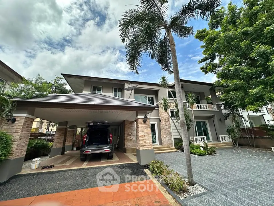 Stunning modern two-story house with spacious driveway and lush landscaping.