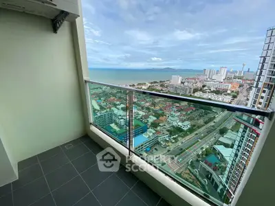 Stunning high-rise balcony with panoramic ocean and city views, perfect for urban living.