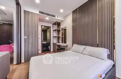 Modern bedroom with stylish decor and ensuite bathroom in luxury apartment