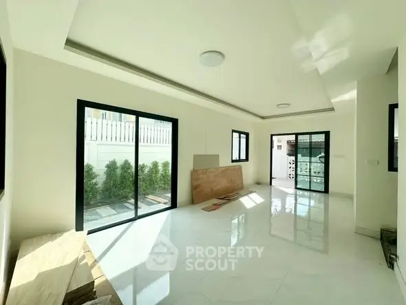 Spacious modern living room with large windows and garden view