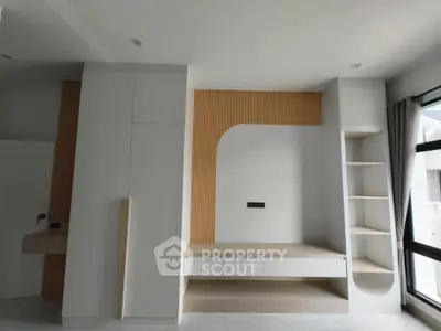 Modern minimalist interior with built-in storage and natural light