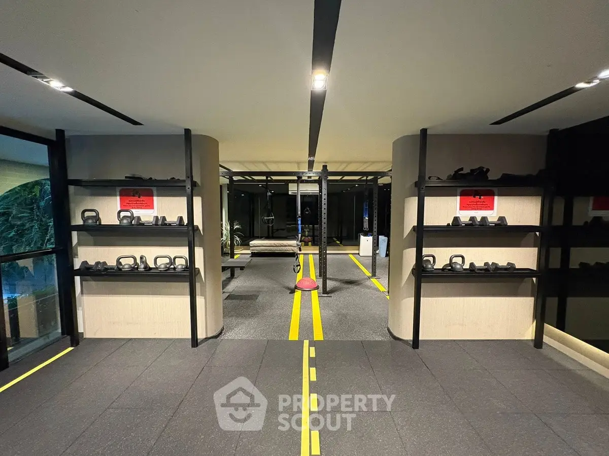 Modern gym with kettlebells and sleek design in luxury real estate property.