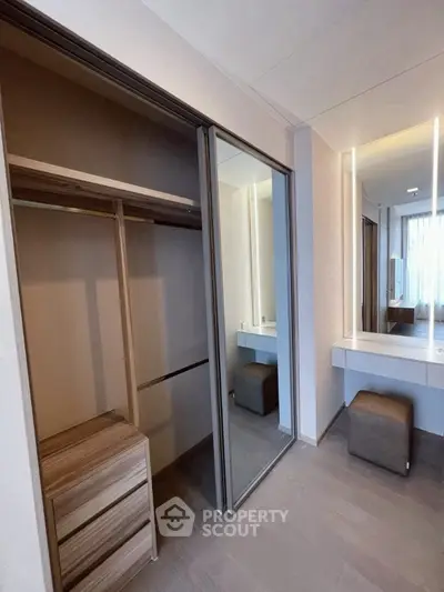 Modern bedroom with mirrored closet and stylish vanity area