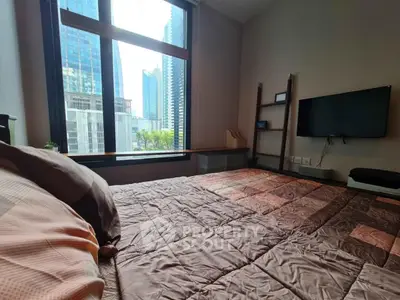 Modern bedroom with city view and wall-mounted TV in high-rise apartment