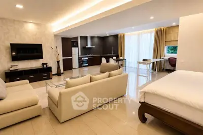Spacious open-plan living room with modern kitchen and elegant decor