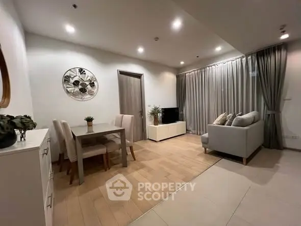 Modern living room with elegant decor and cozy seating area, perfect for relaxation and entertainment.