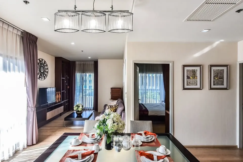 Elegant open-plan living and dining area with modern decor and natural light.