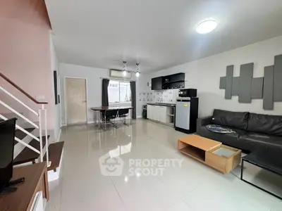 Spacious modern living room with open kitchen and sleek furnishings