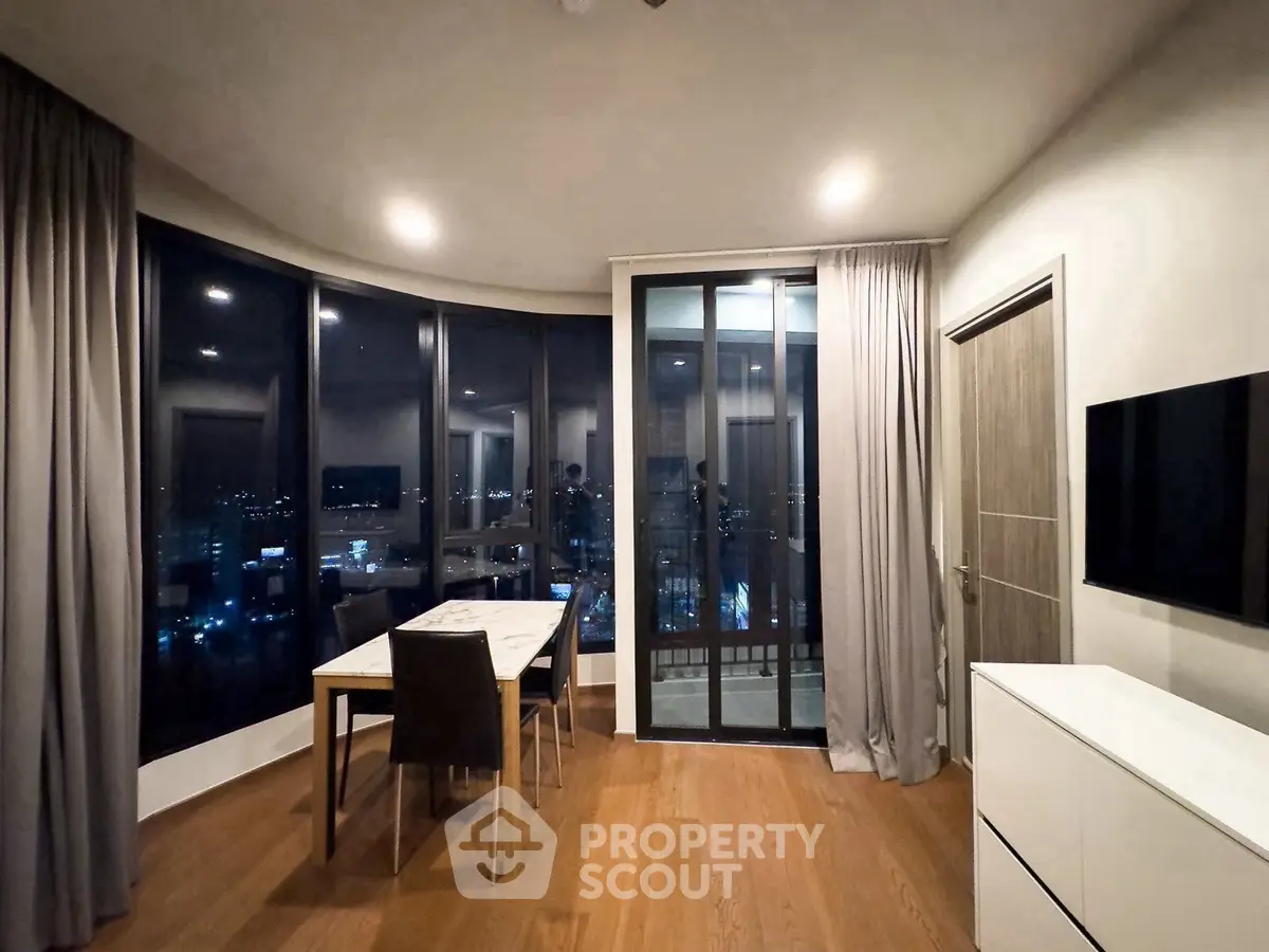 Modern living room with panoramic city view and elegant dining area