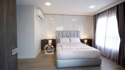 Modern bedroom with stylish decor and natural light