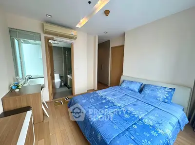 Spacious bedroom with ensuite bathroom in modern apartment