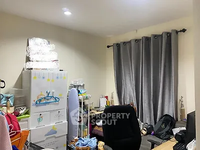 Cozy cluttered room with storage and office chair, ideal for creative workspace.
