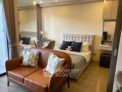 Modern bedroom with stylish decor and cozy seating area, perfect for relaxation and comfort.