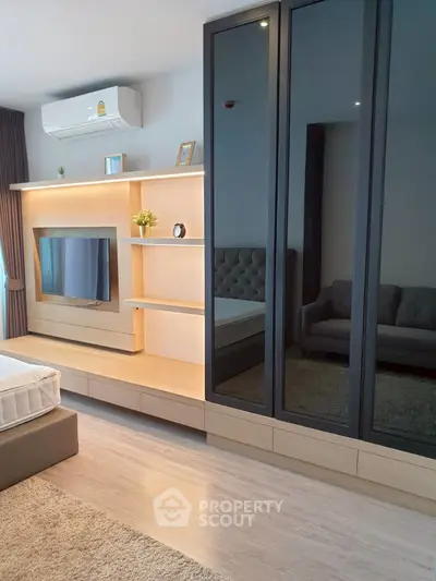 Modern bedroom with sleek built-in wardrobe and stylish TV unit