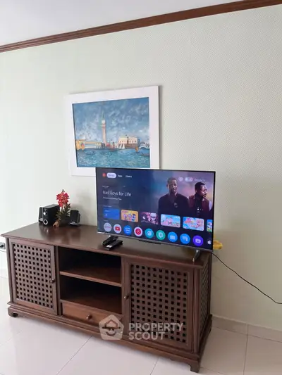 Stylish living room with modern TV setup and elegant wooden cabinet