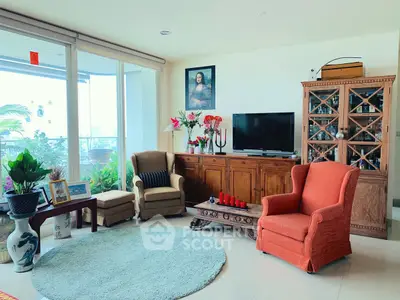 Charming living room with elegant furniture and balcony view, perfect for relaxation and entertaining.