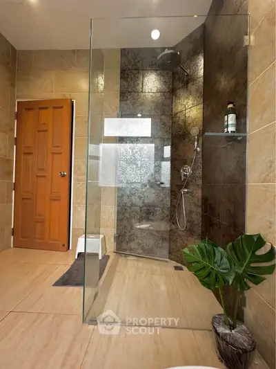 Luxurious bathroom with glass shower and modern tile design