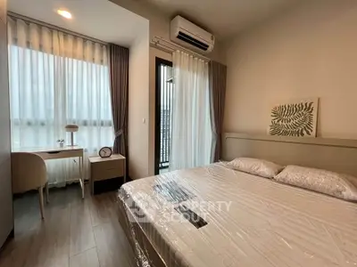 Modern bedroom with large windows, stylish decor, and natural light in a contemporary apartment.