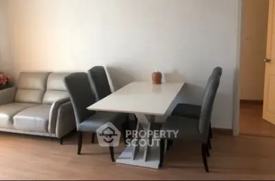 Modern dining area with sleek table and chairs in a cozy living space