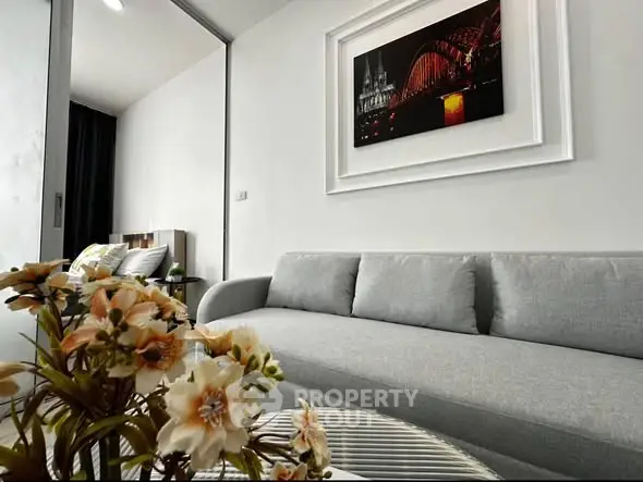 Modern living room with stylish sofa and elegant wall art in a cozy apartment.