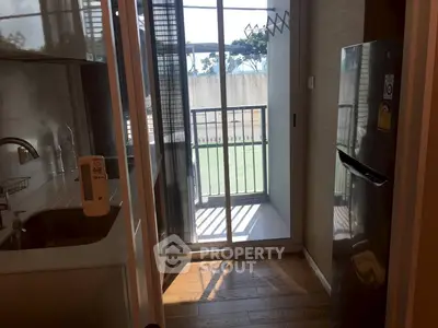 Compact kitchen with balcony access and modern appliances