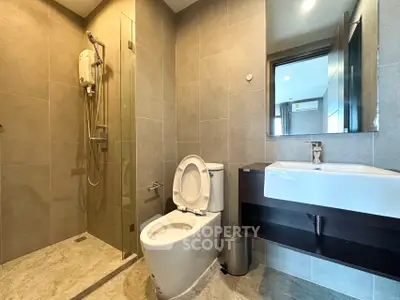 Modern bathroom with sleek fixtures and glass shower enclosure