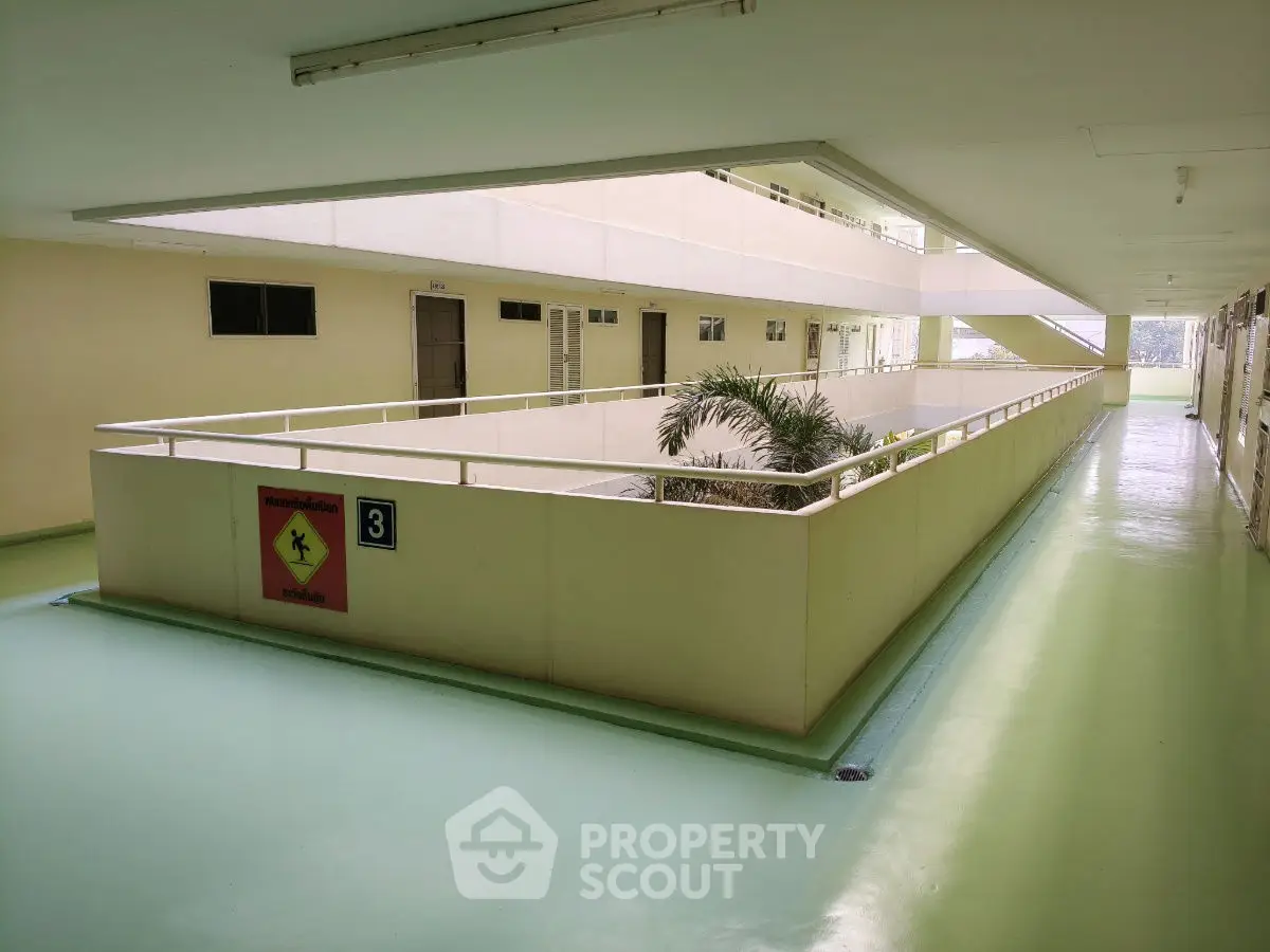 Spacious corridor with safety signage in modern building