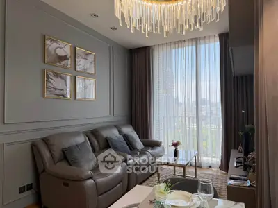Luxurious living room with elegant chandelier and floor-to-ceiling windows offering stunning city views.