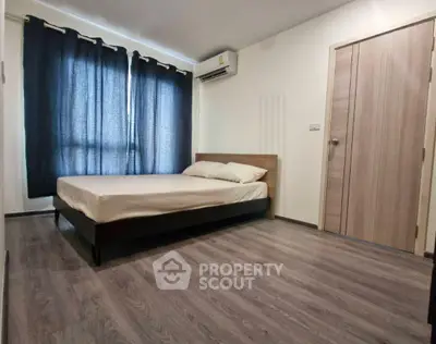 Spacious bedroom with modern flooring and natural light