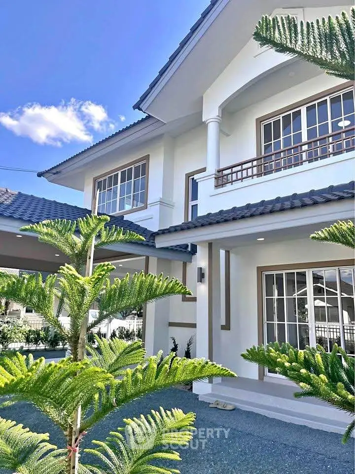 Stunning modern house exterior with lush greenery and elegant architectural design.