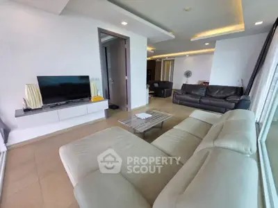 Spacious modern living room with sleek furniture and ambient lighting