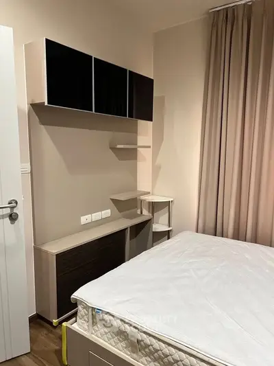 Modern bedroom with sleek storage and neutral decor, perfect for urban living.