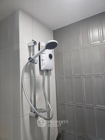 Modern bathroom shower with sleek design and tiled walls, perfect for contemporary living.