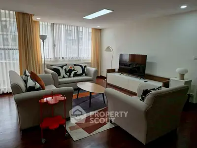 Spacious living room with modern furniture and large windows for natural light.