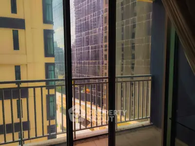 Modern apartment balcony with city view and glass railing