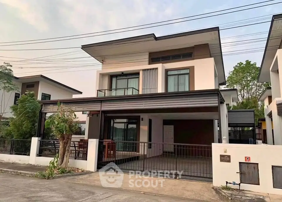 Modern two-story house with sleek design and spacious driveway in a serene neighborhood.