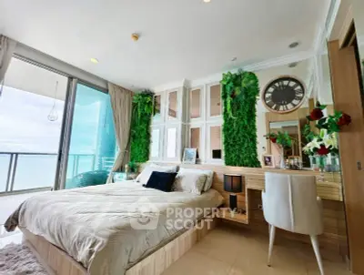 Luxurious bedroom with ocean view and elegant decor, featuring a large balcony and stylish furnishings.