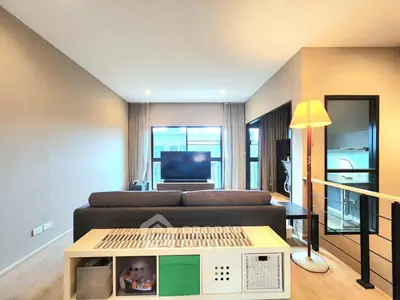 Modern living room with stylish decor and large window view