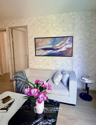 Modern living room with stylish sofa, abstract art, and elegant decor