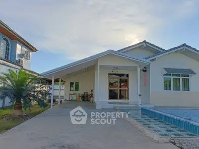 Charming single-story home with spacious driveway and modern exterior design.