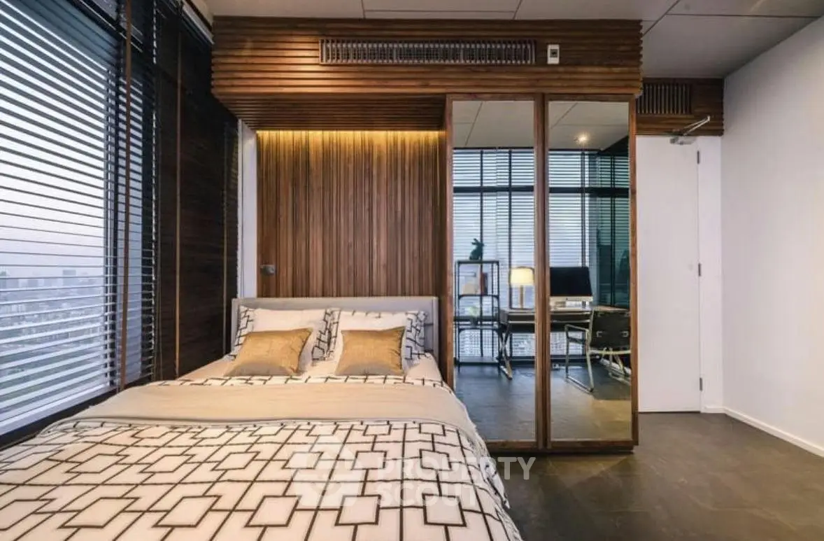 Modern bedroom with stylish wooden accents and large mirrored wardrobe