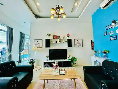 Stylish living room with modern decor, elegant lighting, and cozy seating area.