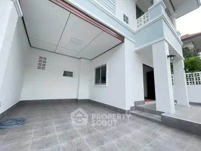 Modern two-story house with spacious tiled entrance and clean exterior design