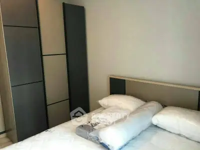 Modern bedroom with sleek wardrobe and cozy bedding in a stylish apartment.