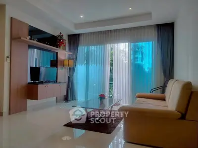 Elegant living room with modern decor and large windows offering natural light.