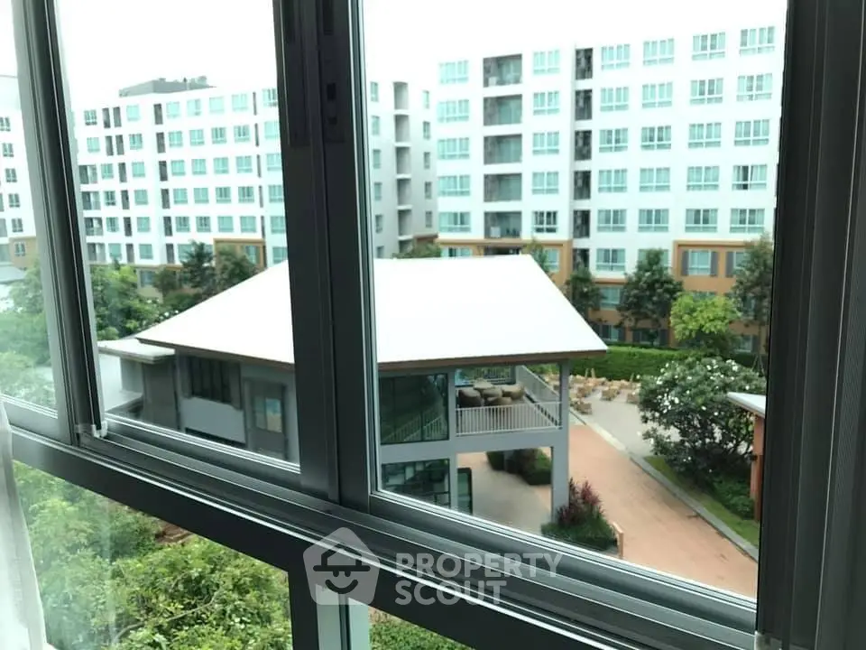 Modern apartment view with lush greenery and contemporary architecture