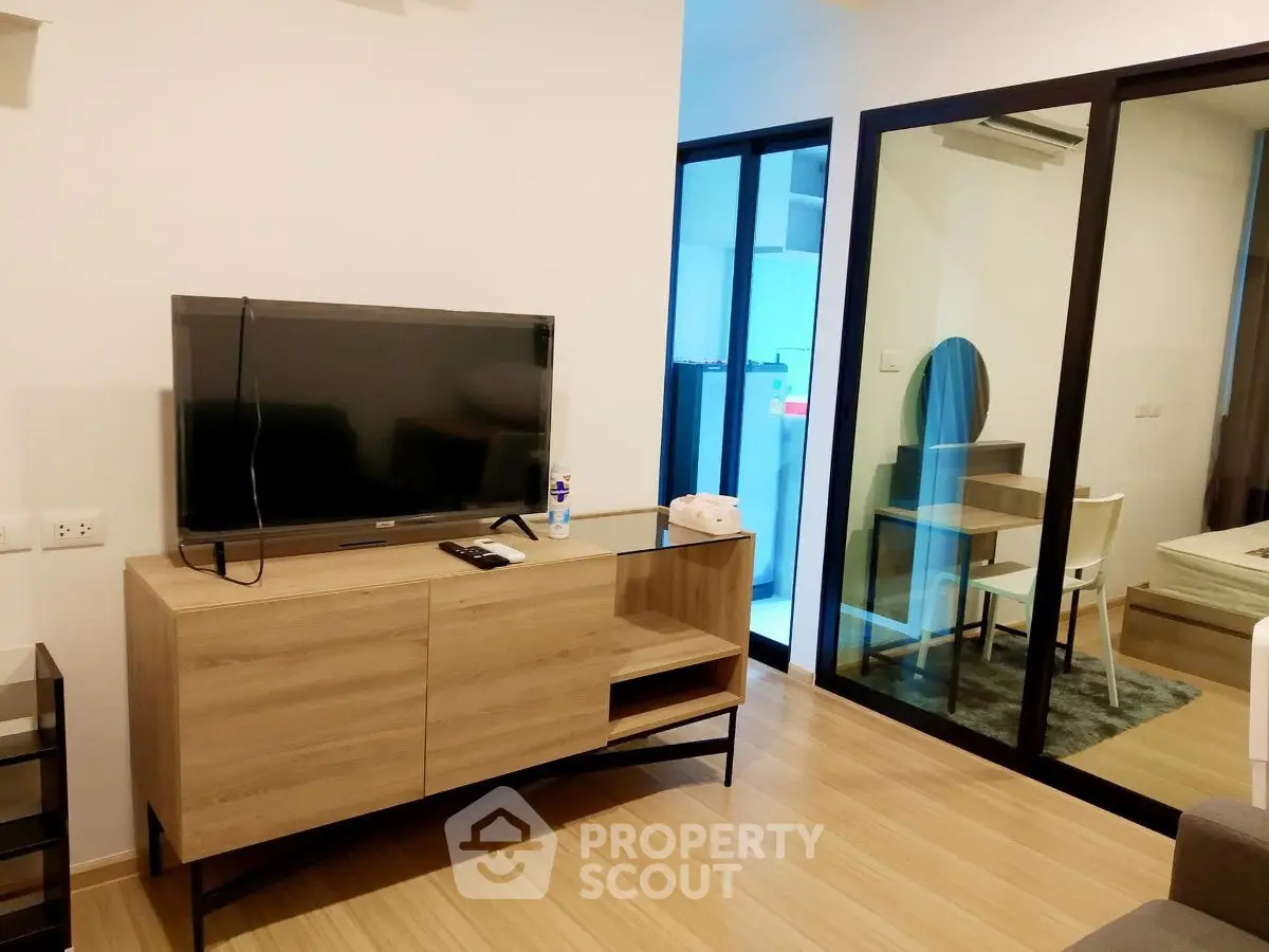 Modern living room with sleek wooden flooring and stylish TV cabinet