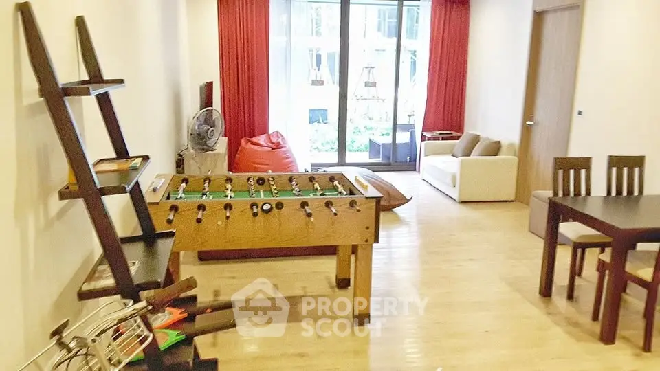 Spacious living room with foosball table and modern furniture