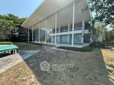 Stunning modern villa with expansive garden and sleek architectural design.