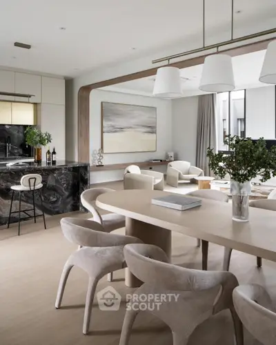 Luxurious open-plan kitchen and dining area with modern decor and elegant lighting.